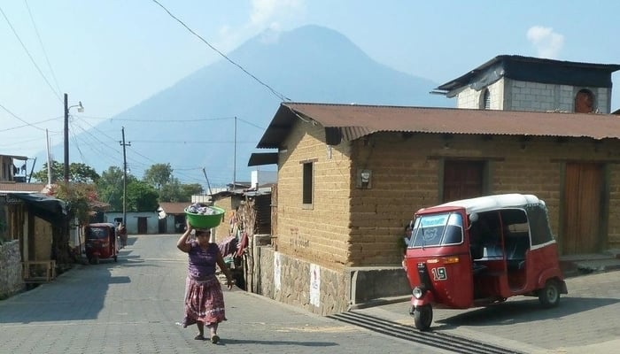 Social media in Guatemala / This woman probably has a cellphone on her. Ditto the tuk-tuk driver 